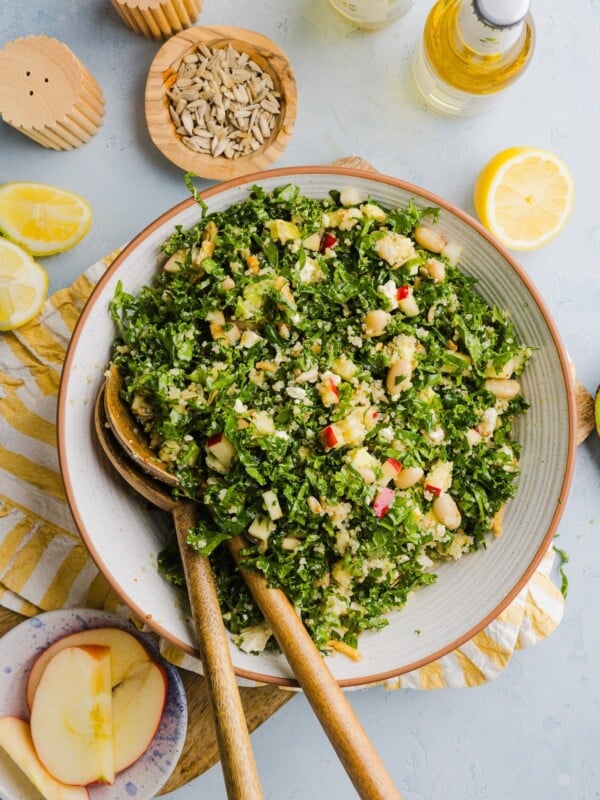 Kale white bean salad tossed in a large mixing bowl.
