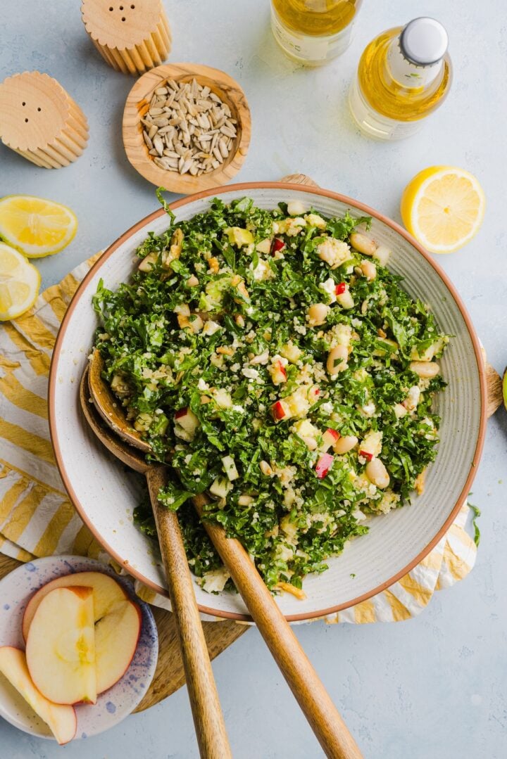 Kale white bean salad tossed in a large mixing bowl.
