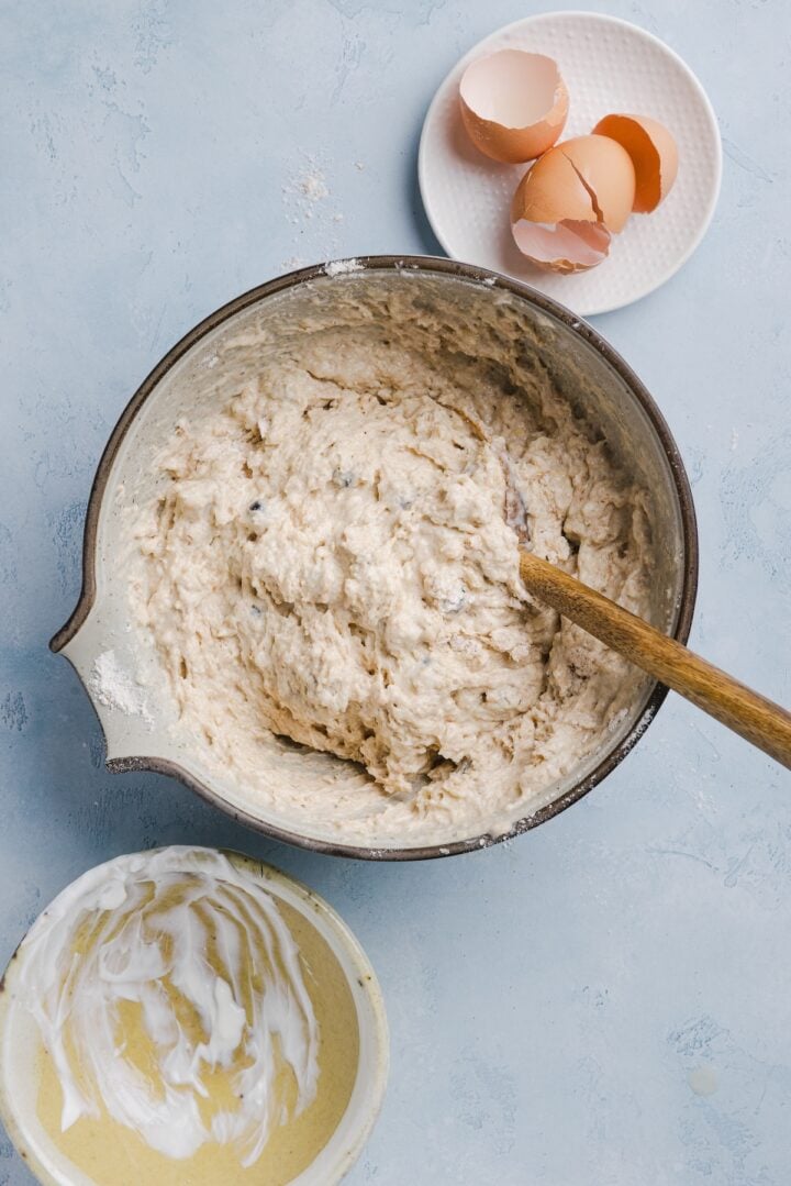 Batter for whole wheat blueberry muffins in a large white mixing bowl.