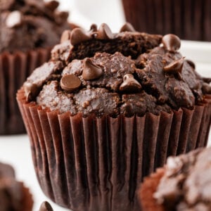 Double Chocolate Banana Muffins on a white marble counter top.