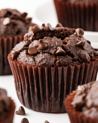 Double Chocolate Banana Muffins on a white marble counter top.