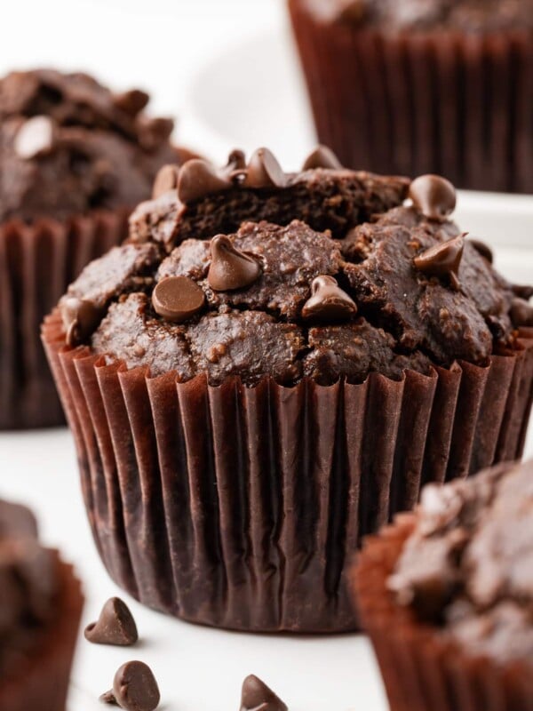 Double Chocolate Banana Muffins on a white marble counter top.