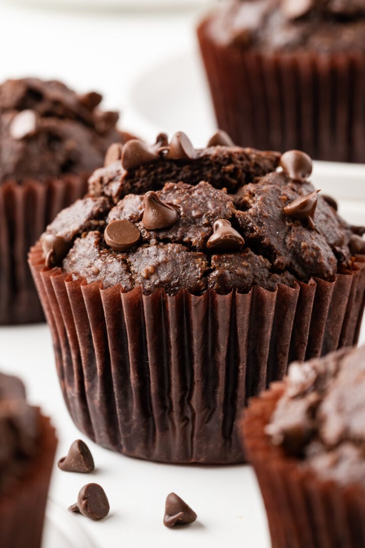 Double Chocolate Banana Muffins on a white marble counter top.