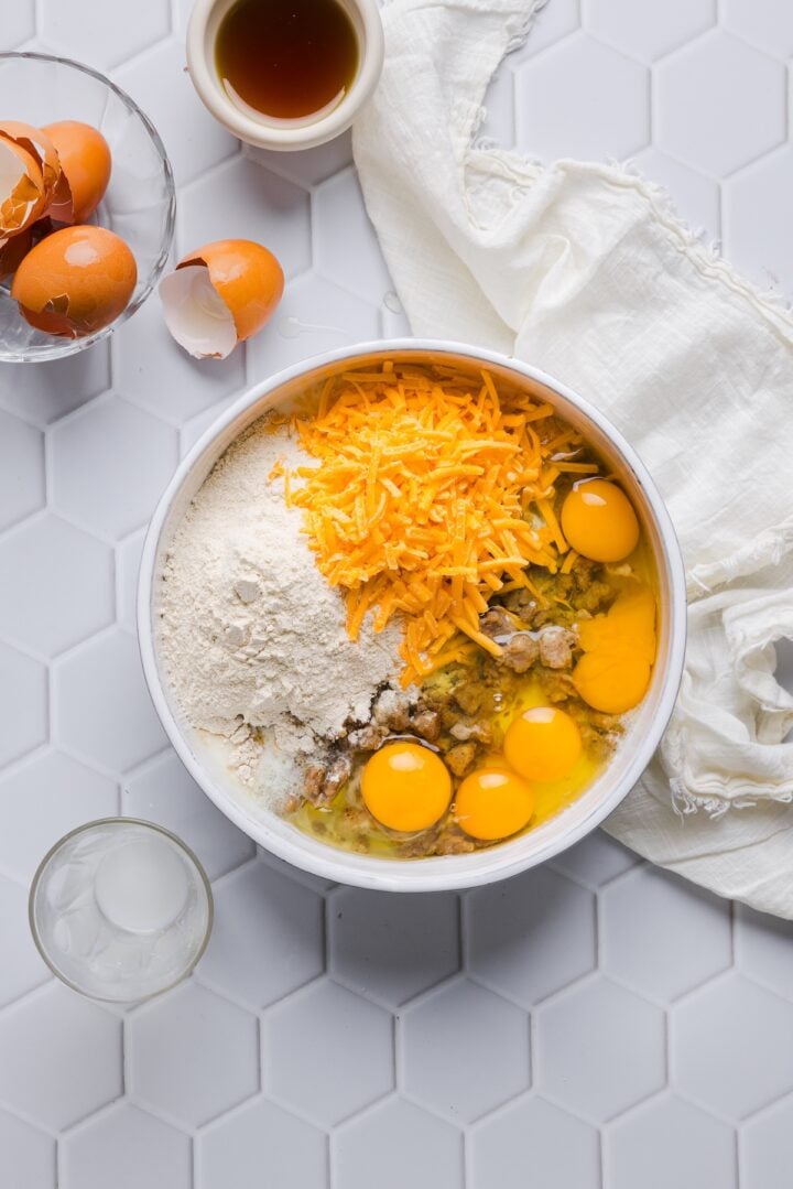 Ingredients for protein mcgriddle muffins in a large white bowl, unmixed.