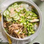 Tuna mayo rice bowl on a green marble kitchen counter.