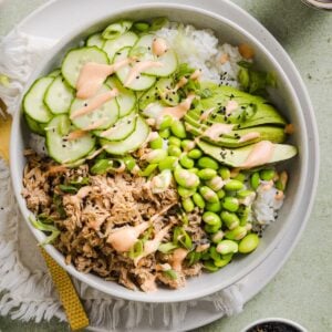 Tuna mayo rice bowl on a green marble kitchen counter.