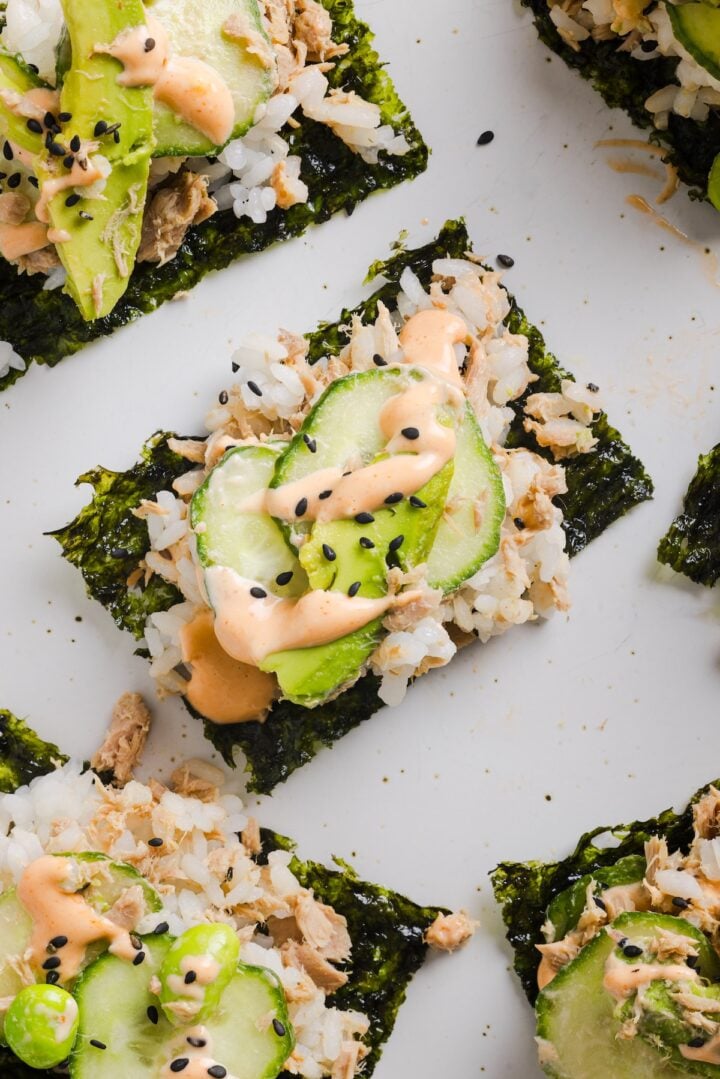 Tuna mayo rice bowl mixed and placed on seaweed snacks for hand-held sushi bites.