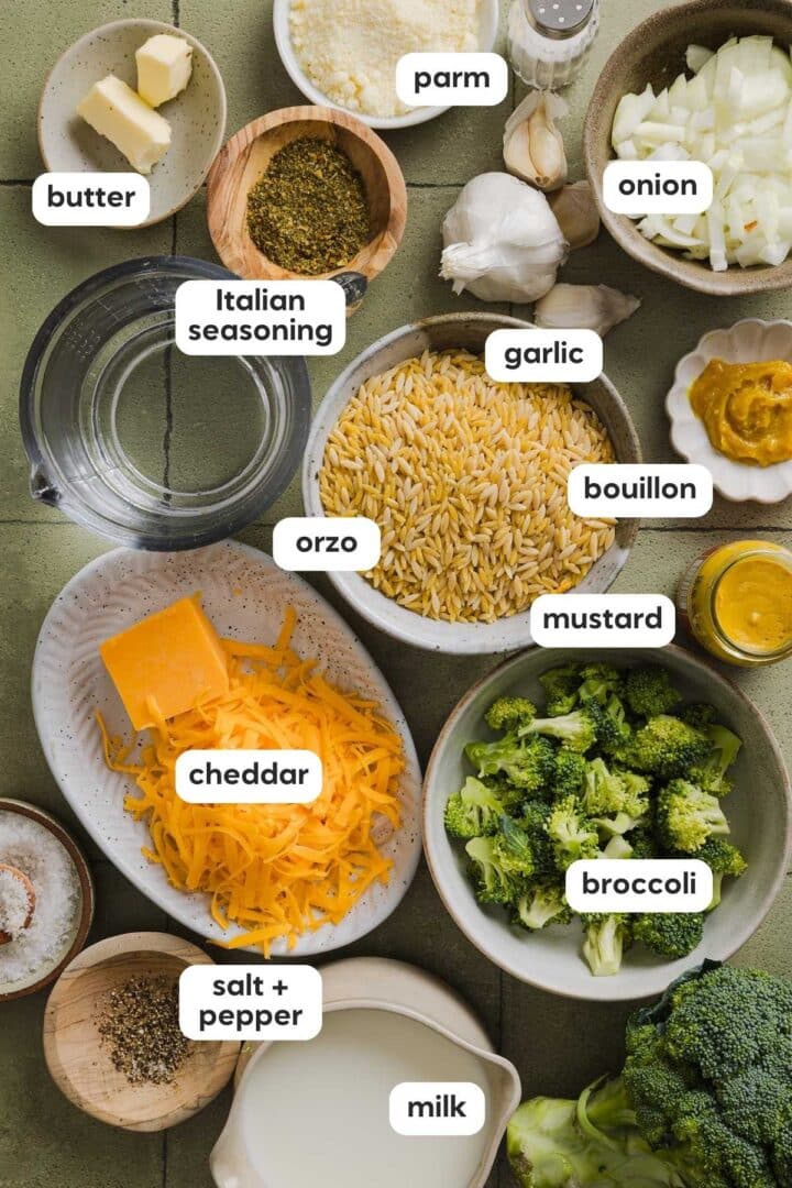 Ingredients for broccoli cheddar orzo in small bowls on a kitchen counter.