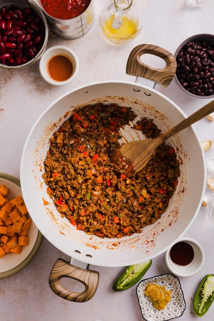 Ground beef and veggies cooked in a large pot.