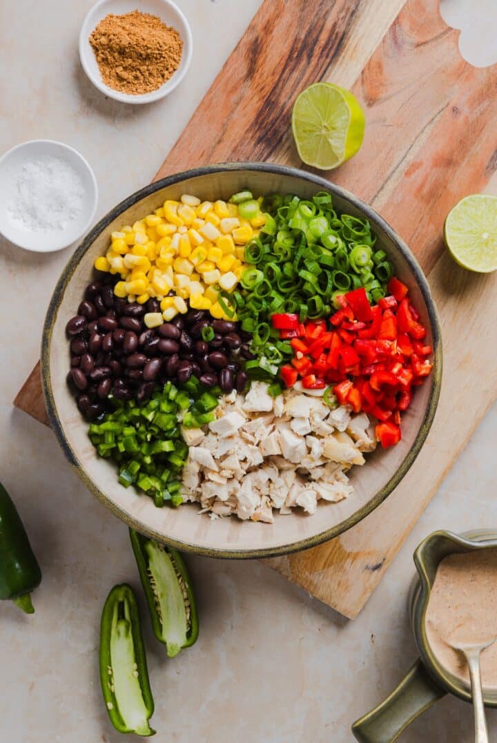 Ingredients for southwest chicken salad in a large mixing bowl.
