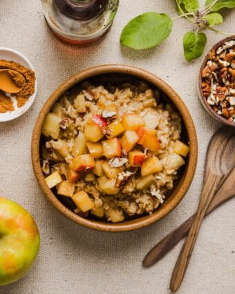 Apple cinnamon oatmeal in a wooden bowl.