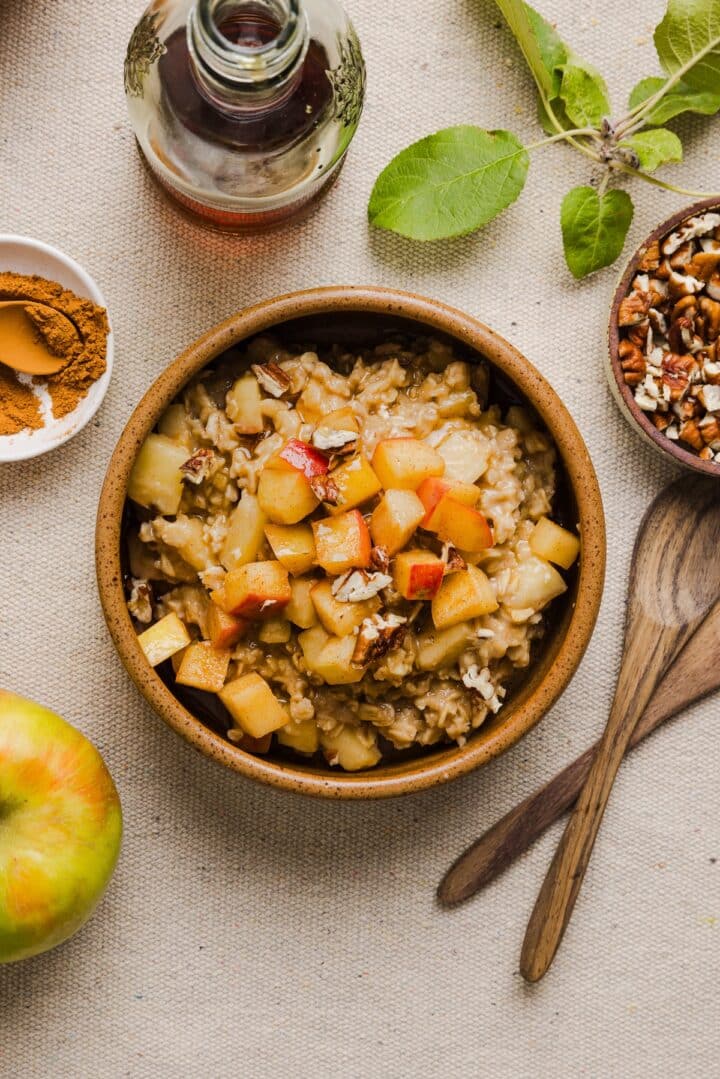 Apple cinnamon oatmeal in a wooden bowl.