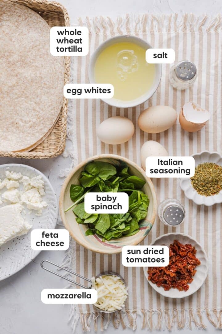 Ingredients for copycat Starbucks spinach feta wraps displayed in small bowls on a kitchen counter.