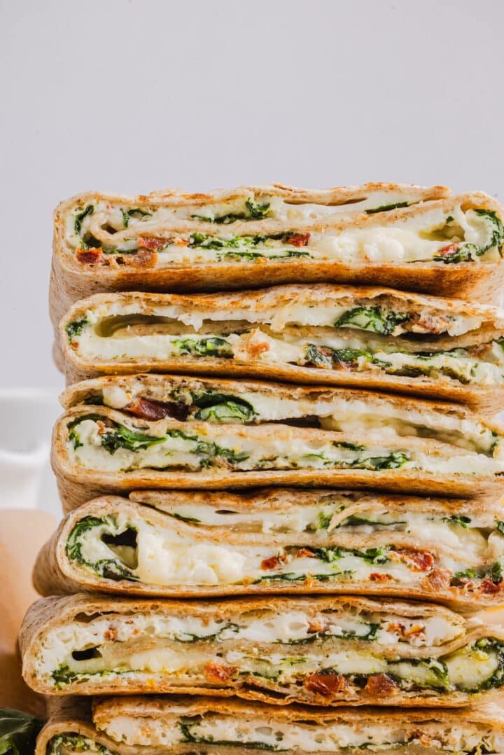 Close-up shot of Starbucks copycat feta spinach wraps piled on a plate.