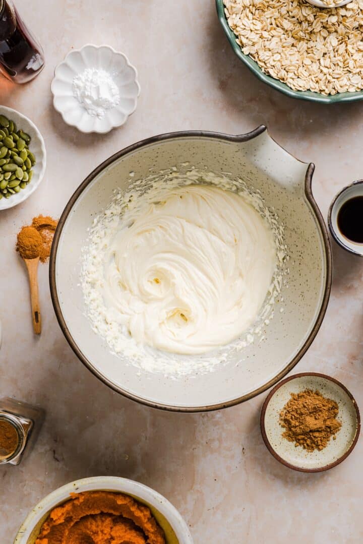Cream cheese whisked in a large bowl.