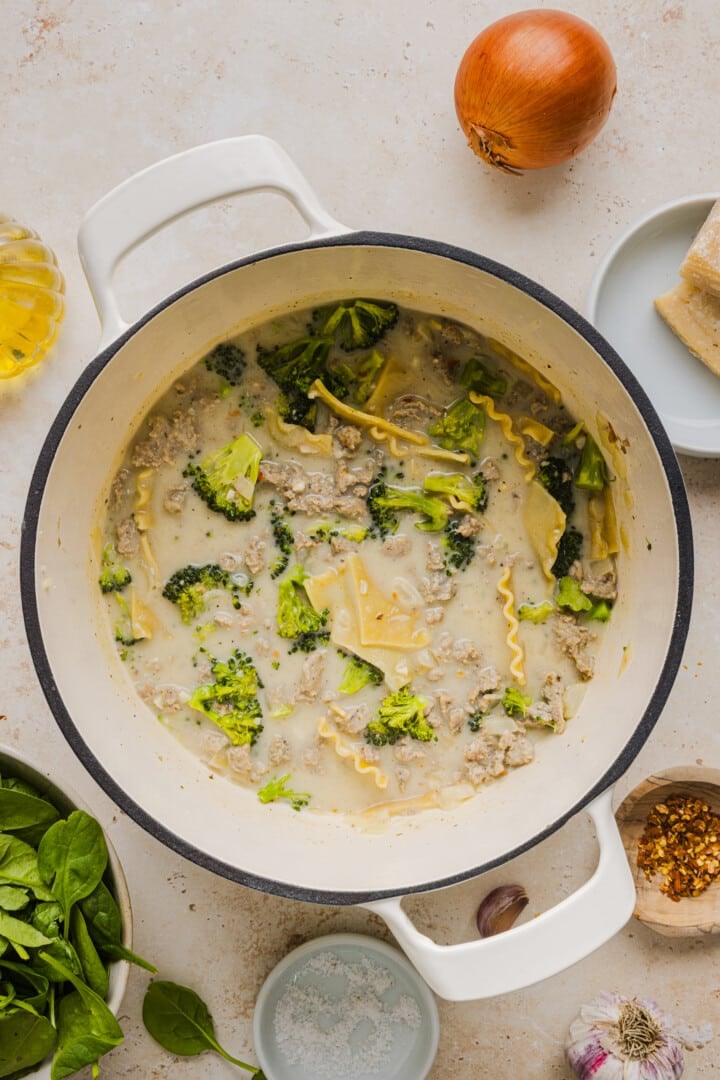 White lasagna soup cooked in a large white pot.