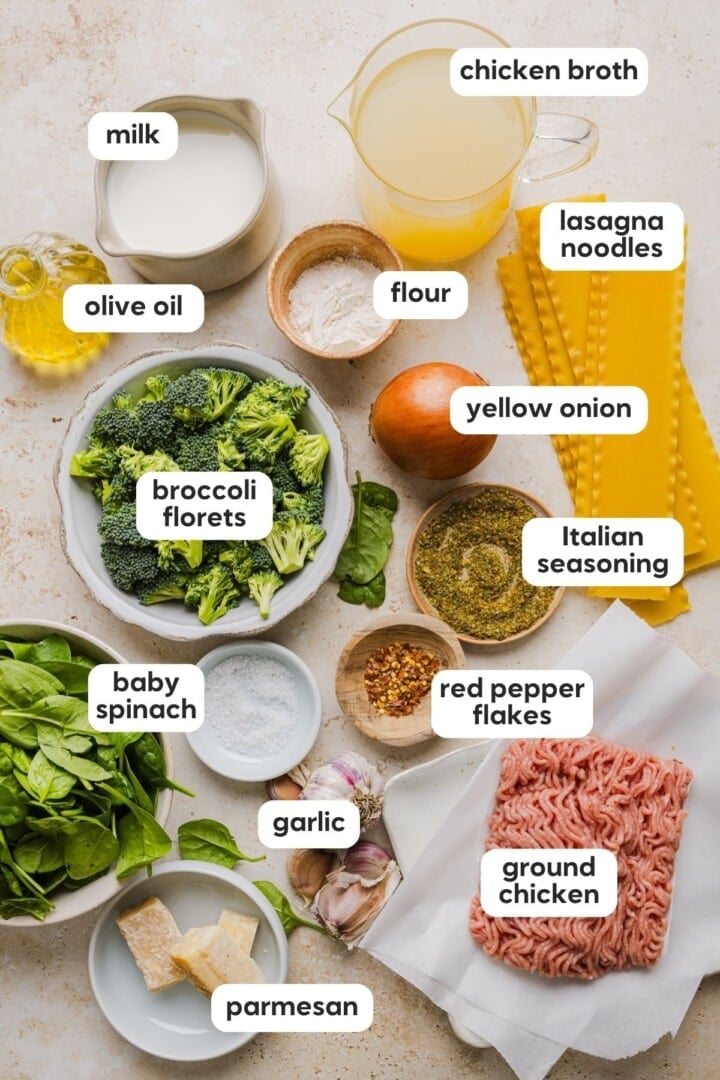 Ingredients for one-pot creamy white lasagna soup displayed in small bowls on a marble counter.