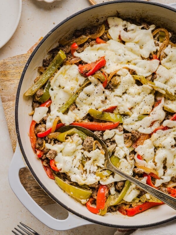 Philly cheesesteak skillet dinner with a serving spoon.