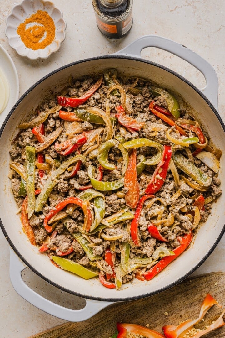 Philly cheesesteak skillet in a pan, before adding provolone on top.