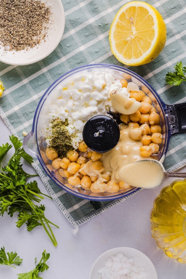 Ingredients for cottage cheese protein hummus in a food processor.