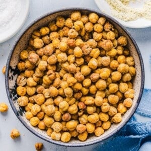 Crispy roasted chickpeas in a bowl on a blue marble counter