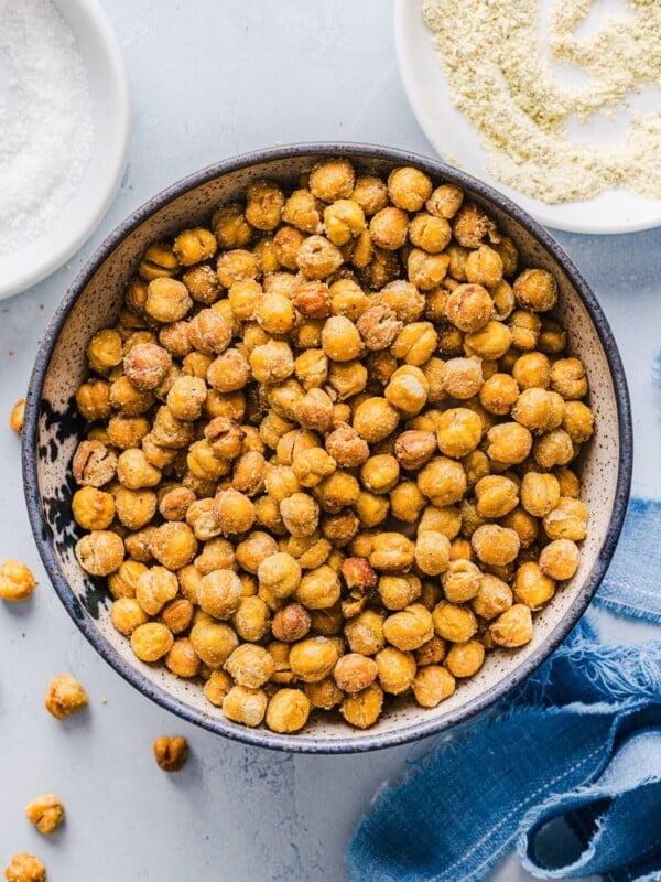 Crispy roasted chickpeas in a bowl on a blue marble counter