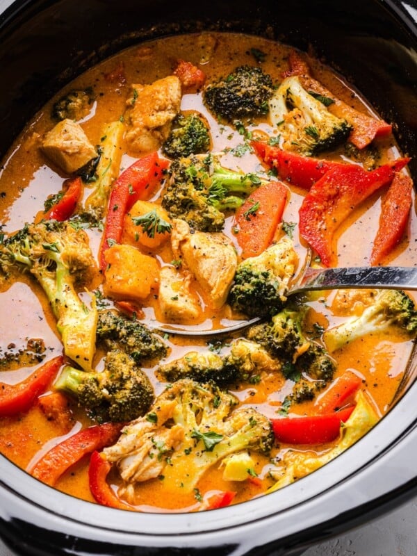 Slow cooker Thai-inspired red curry with chicken and vegetables in a slow cooker.
