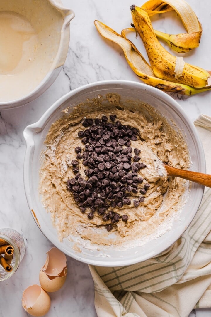 Banana bread batter in a bowl with chocolate chips.
