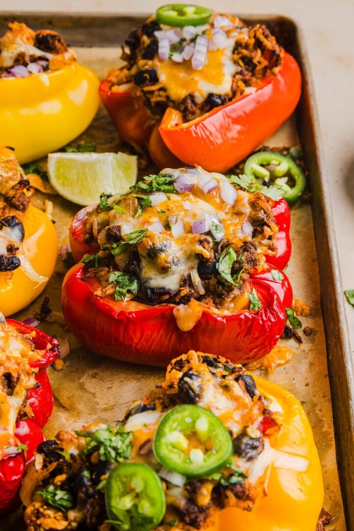 Taco stuffed peppers on a baking tray.