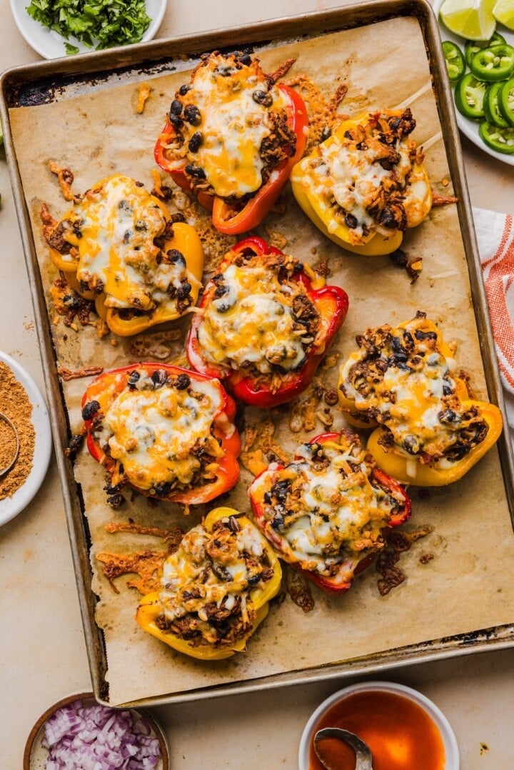 Cooked taco stuffed peppers, topped with cheese.