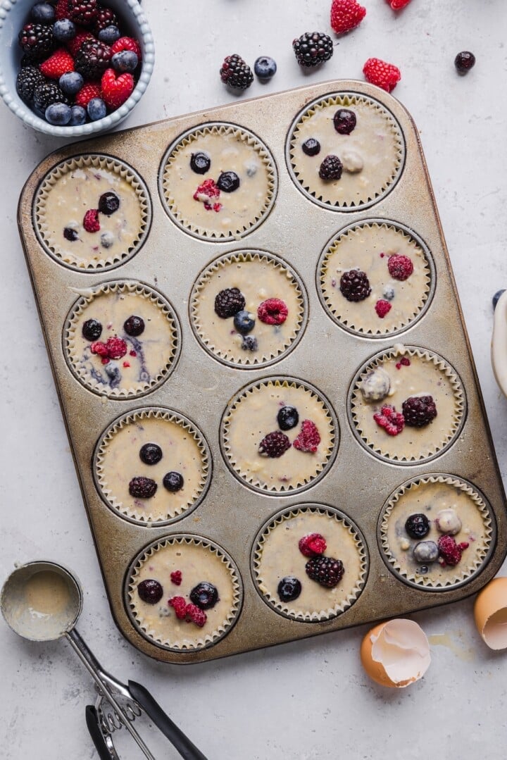 Protein pancake muffins from Kodiak mix unbaked in a lined muffin tin.