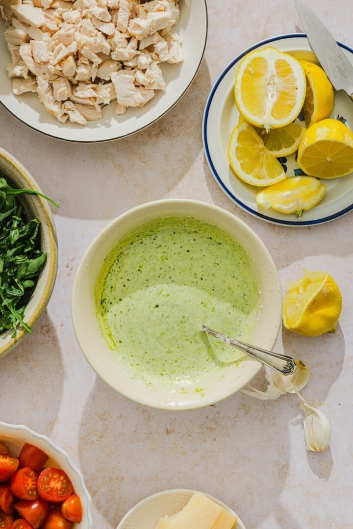 Creamy pesto dressing in a small bowl.