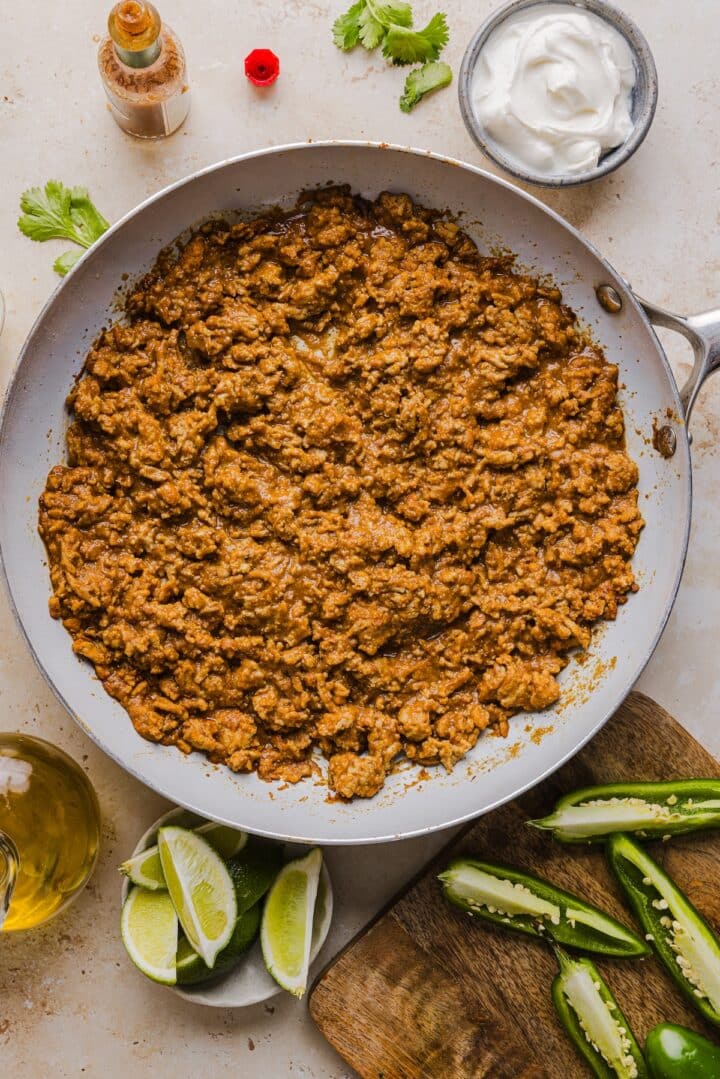 Cooked turkey and beans combined in a pan.