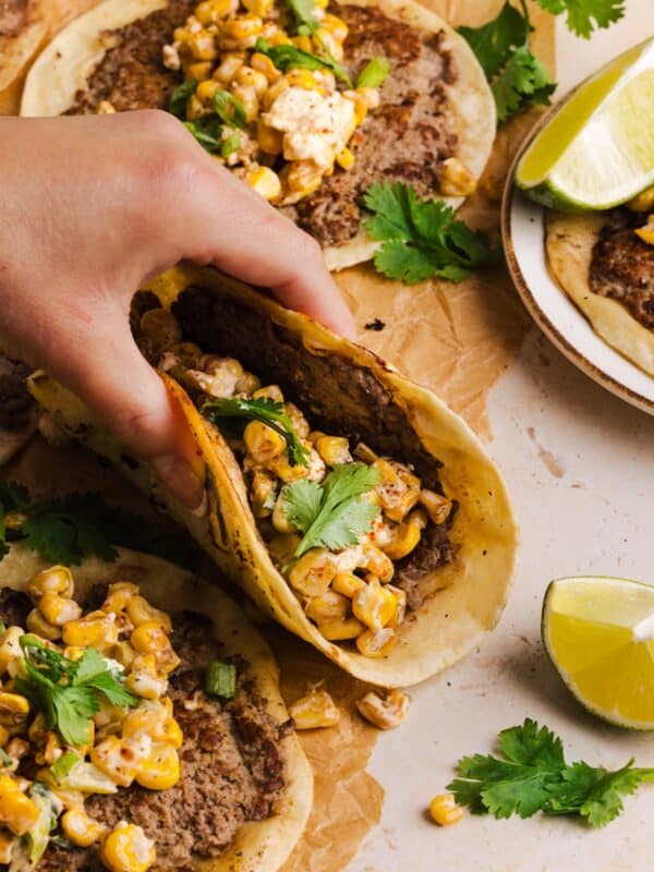 Lifting up a street corn taco.
