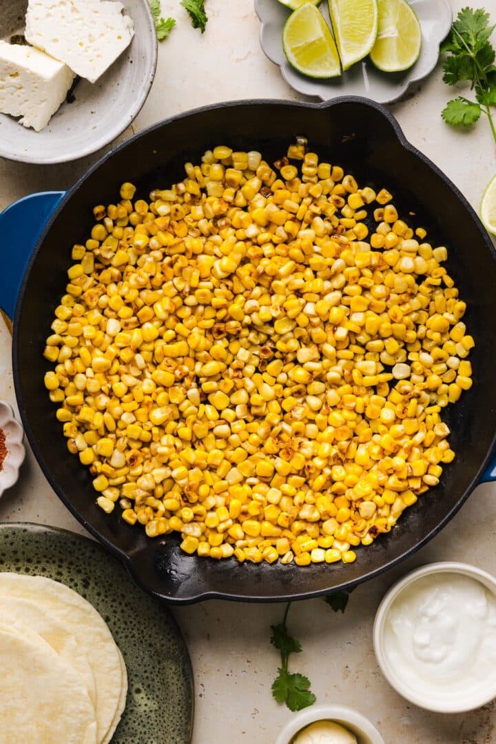 Corn being charred in a pan.