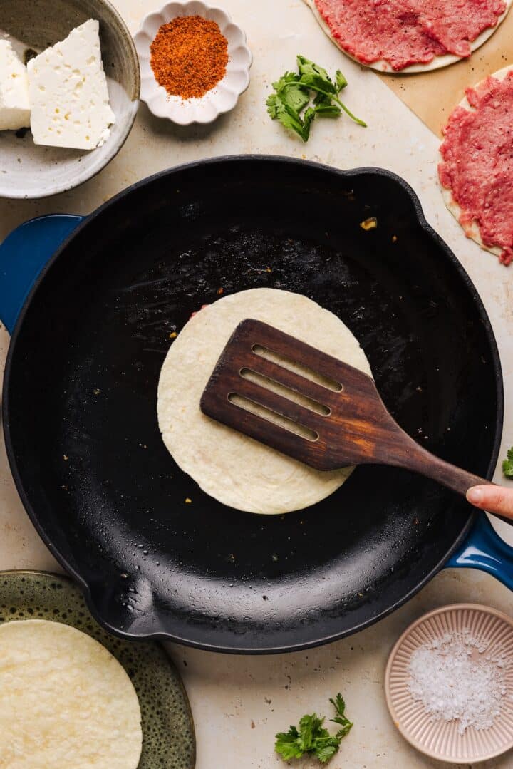 Street corn taco flipped on a skillet.