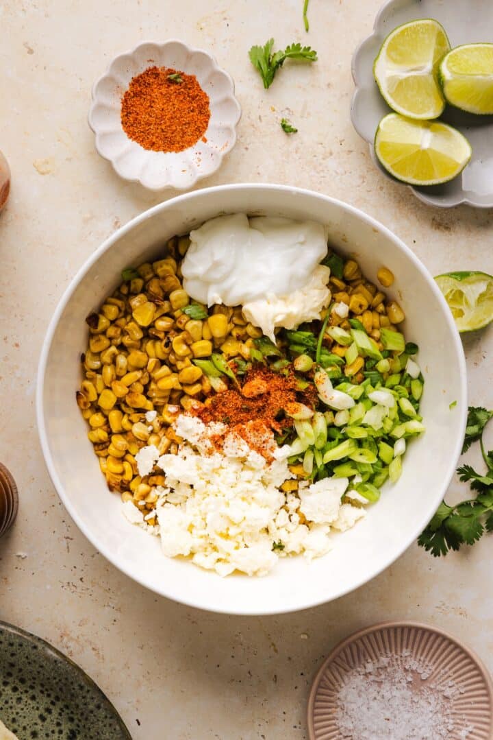 Elote topping ingredients combined in a bowl.