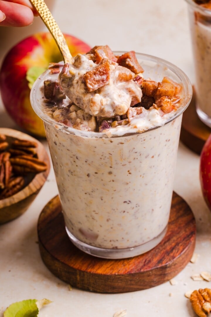 Apple pie overnight oats in a glass jar.
