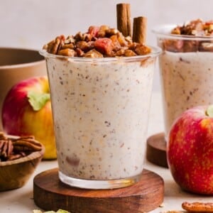 Apple pie overnight oats in a glass jar.