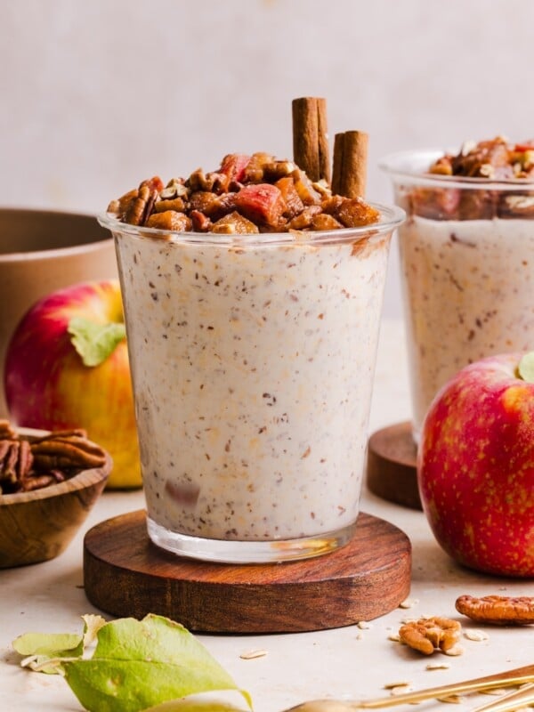 Apple pie overnight oats in a glass jar.