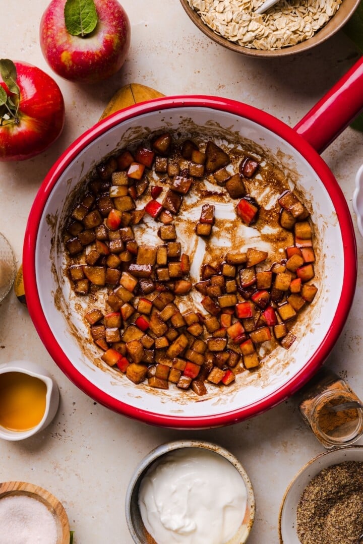 Diced apples in a small pot with cinnamon.