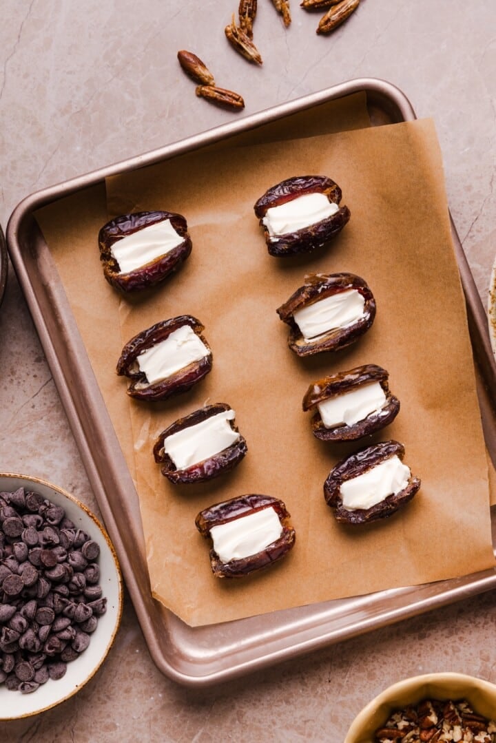 dates on parchment paper stuffed with cream cheese
