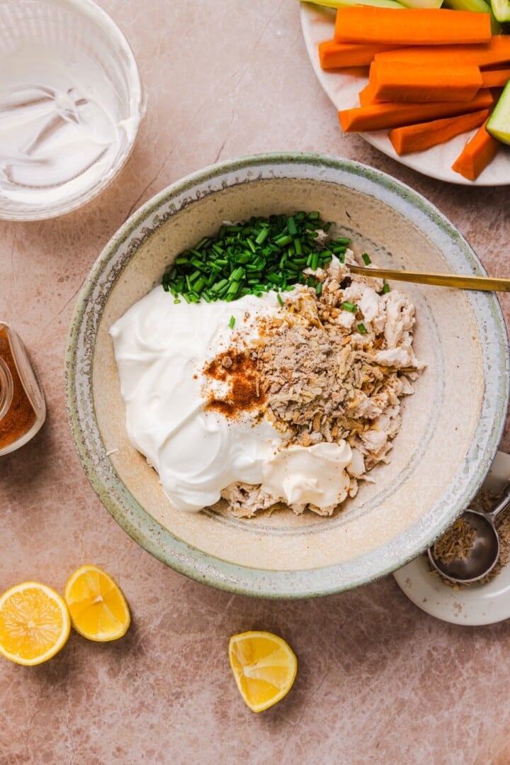 Ingredients for french onion chicken salad in a bowl, unmixed.