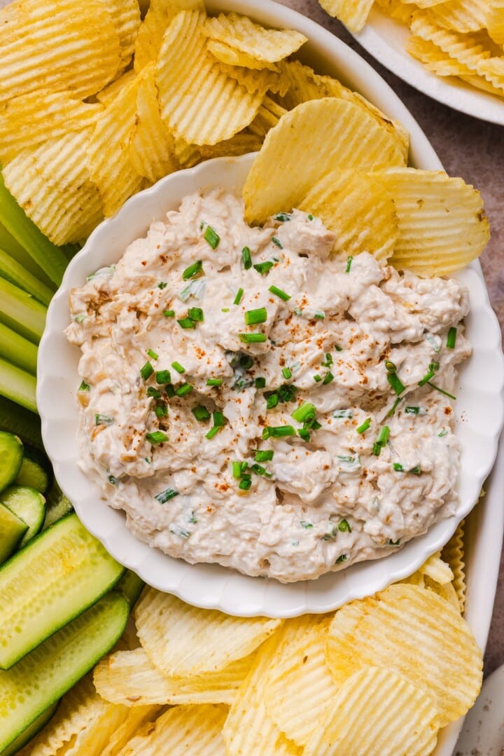 French onion chicken salad served with chips and vegetables.