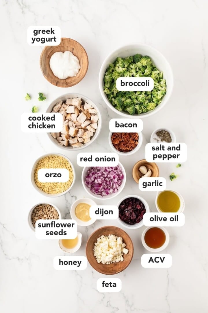Ingredients for broccoli pasta salad in small bowls.