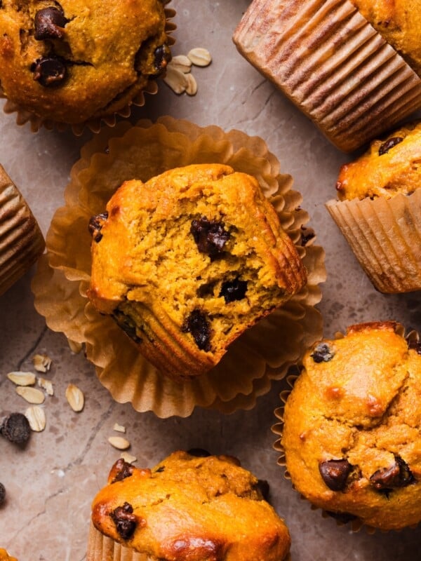 Pumpkin protein muffins on a marble counter.