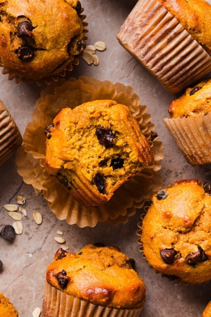 Pumpkin protein muffins on a marble counter.