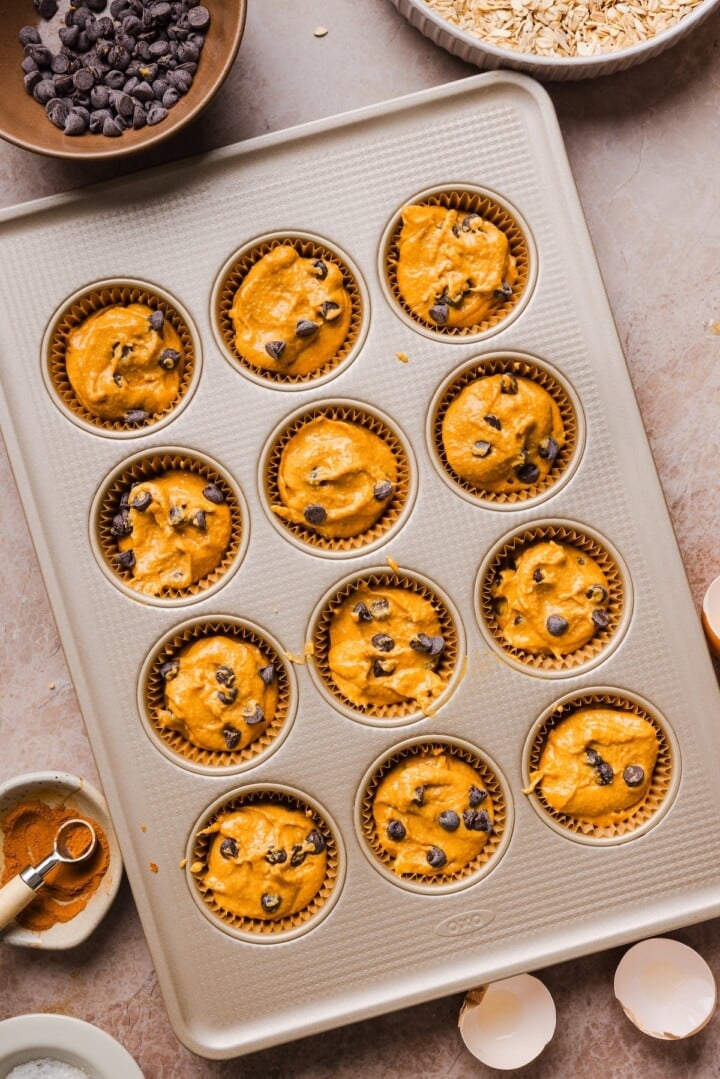 Pumpkin protein muffins raw in a baking pan