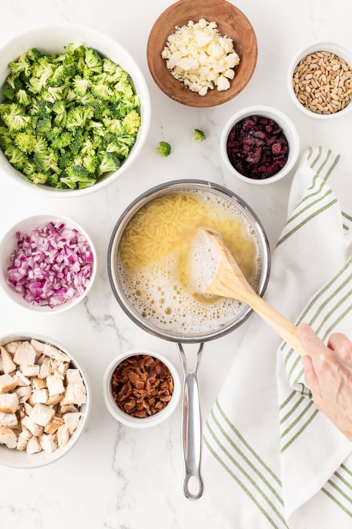 Orzo being cooked in a small pot.