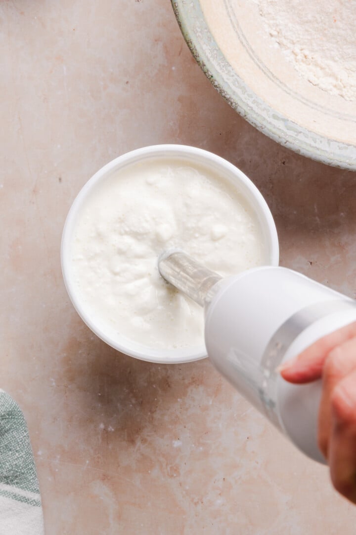 Cottage cheese in tub blended by immersion blender.